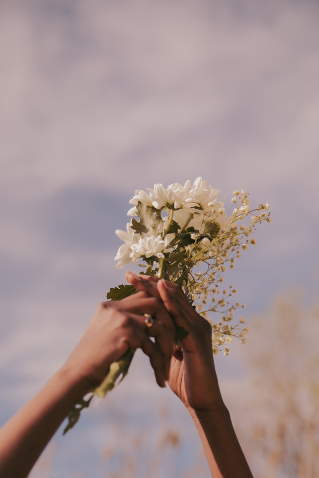 Woman's Hands Holding Flowers